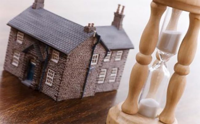 house next to a giant hourglass - mortgage terms